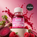 A bottle of Cecii Beet & Berry Live Bacteria + Fibre Shot centered on a pink background with a red juice splash behind it and beet, raspberries, and a beetroot slice arranged around the base. A black circular 'great taste 2024' badge appears in the upper right.
